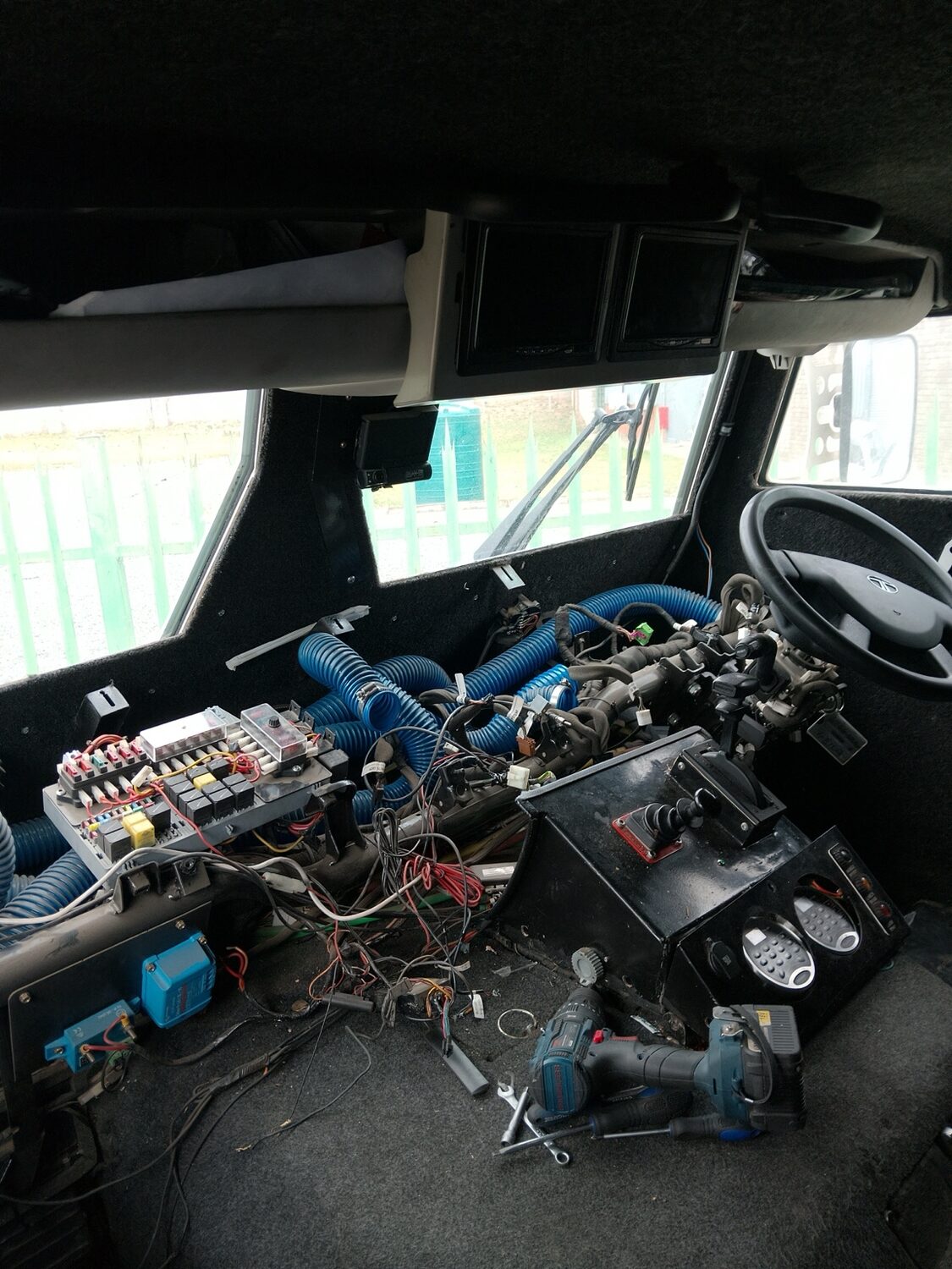 Armoured vehicle dashboard dismantled during a complex aircon repair
